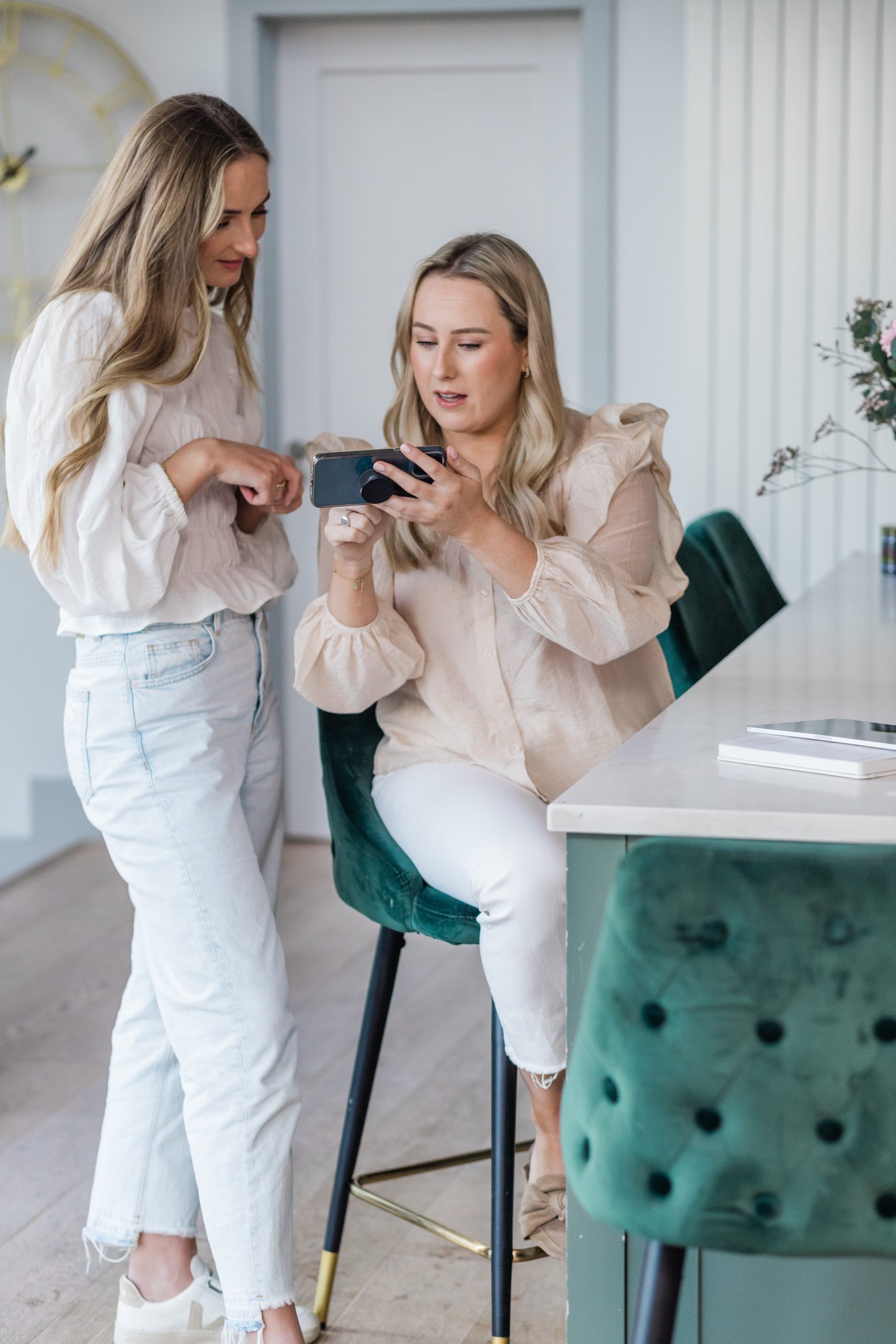two woman with cellphone